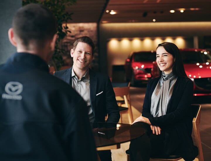 Sitting Customers Smiling at Service Technician